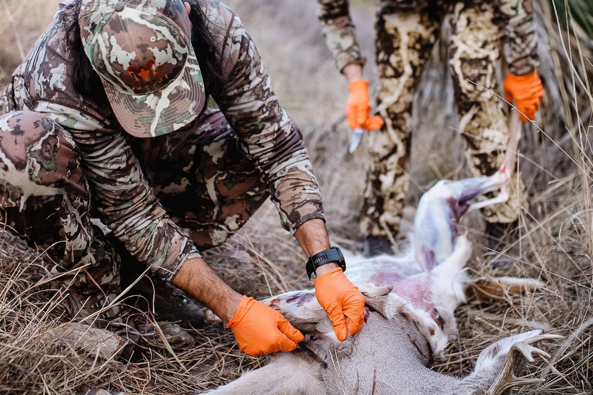 Josh Kirchner and Brad Brooks processing a coues deer in the field